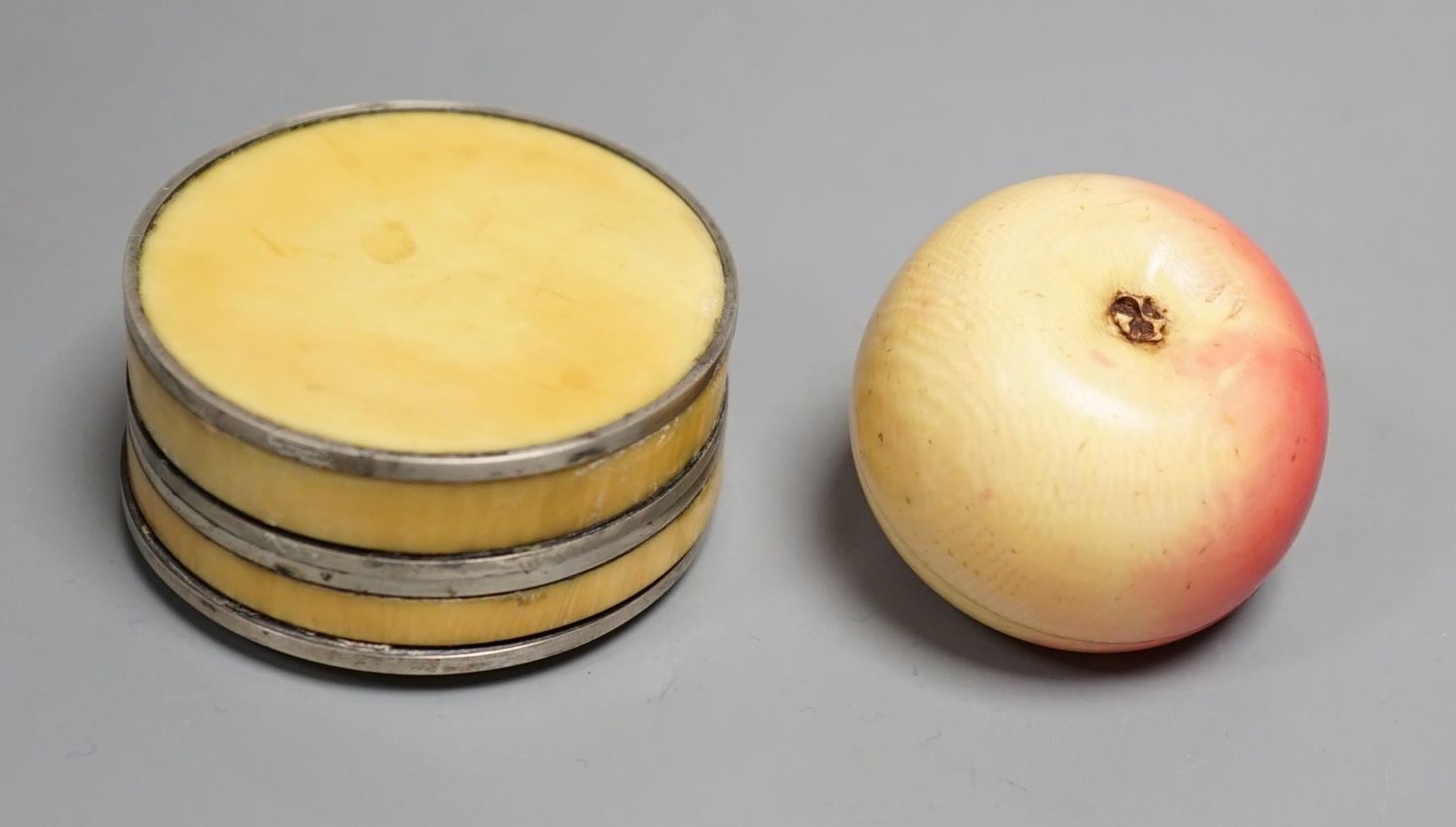 An early 19th century Ivory and blue Jasper mounted box and a 19th century coloured ivory box in the form of an apple (2) largest 5.5cm diameter